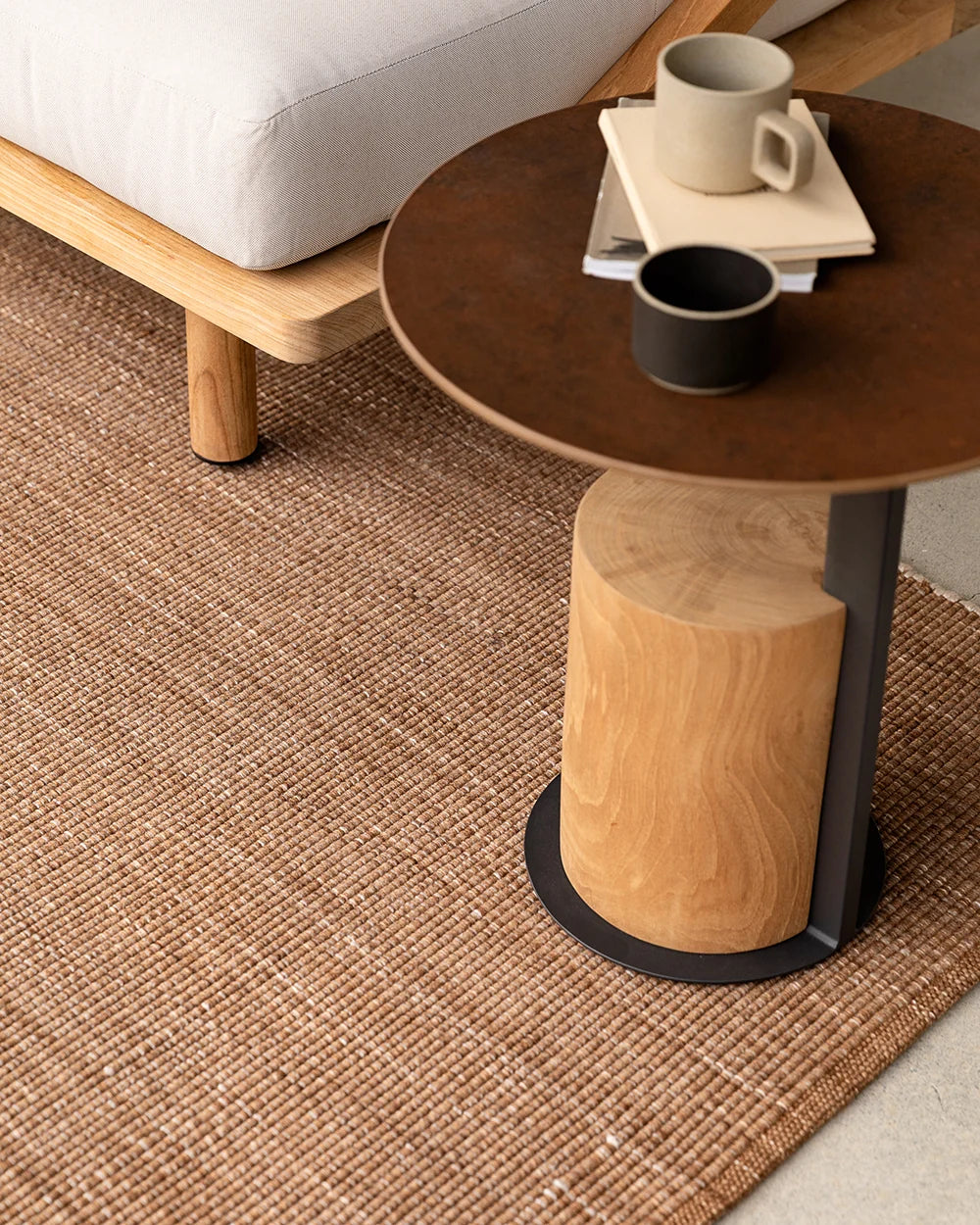 Lonsdale Outdoor Floor Rug in Cumin beneath outdoor lounge furniture