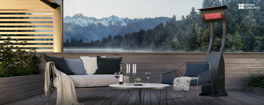A patio heater stands on a deck overlooking scenic mountains in the background.