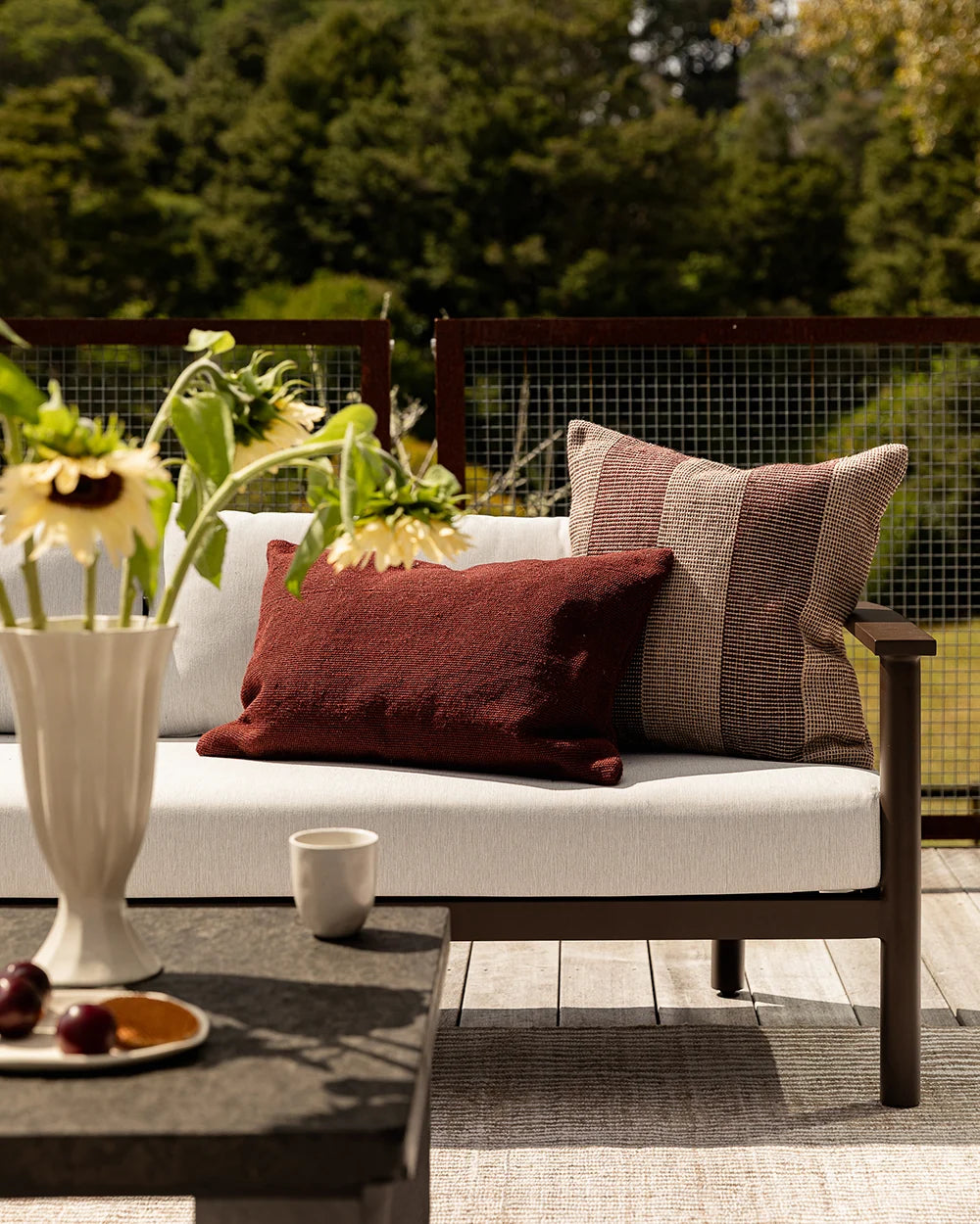 Clipper Outdoor Cushion — Claret cushion lifestyle image, 600 × 400 mm