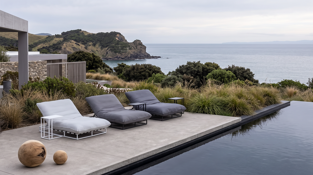 Papamoa daybeds beside an infinity pool on a coastal terrace