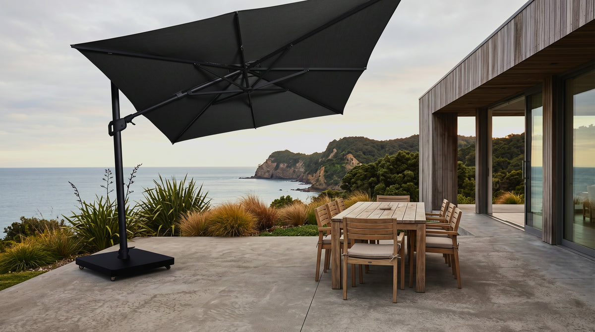 Malibu cantilever umbrella shading a teak dining setting