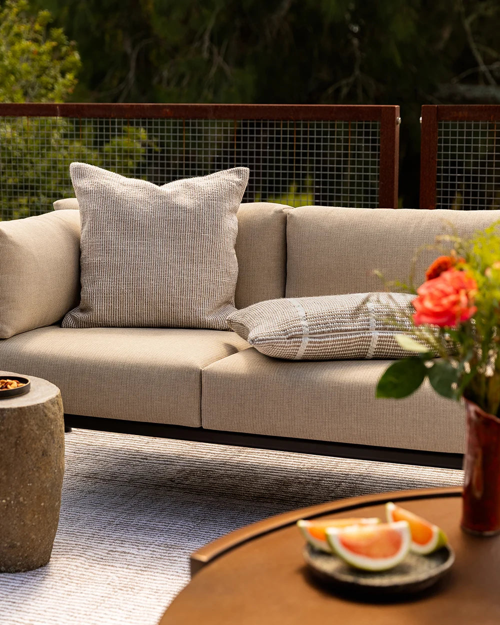 Dune Outdoor Throw Cushion in Almond – styled view