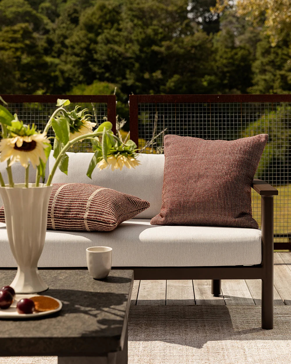 Dune Outdoor Throw Cushion in Claret – styled view