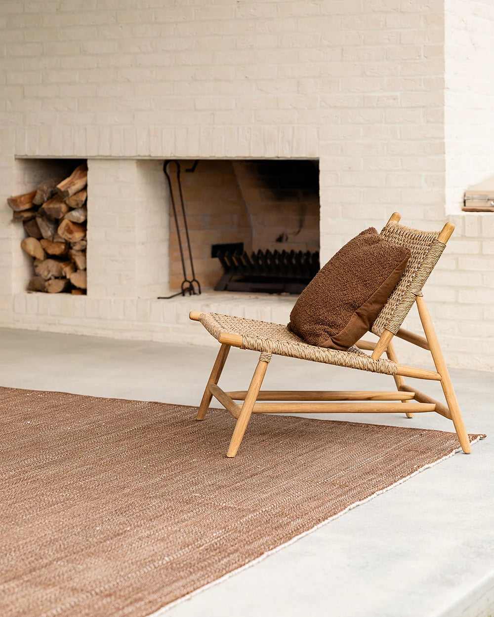 Lonsdale Outdoor Floor Rug in Cumin styled in a contemporary outdoor setting
