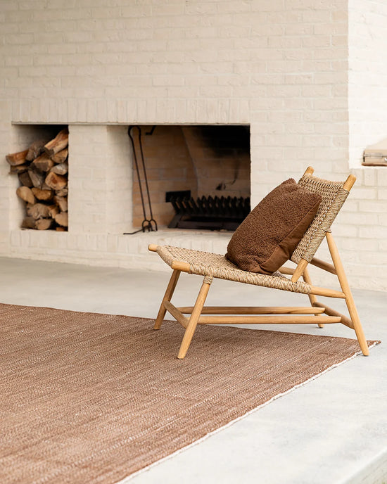 Lonsdale Outdoor Floor Rug in Cumin styled in a contemporary outdoor setting