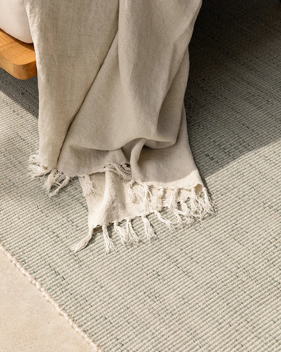 Lonsdale Outdoor Floor Rug in Eucalyptus styled in a covered outdoor space